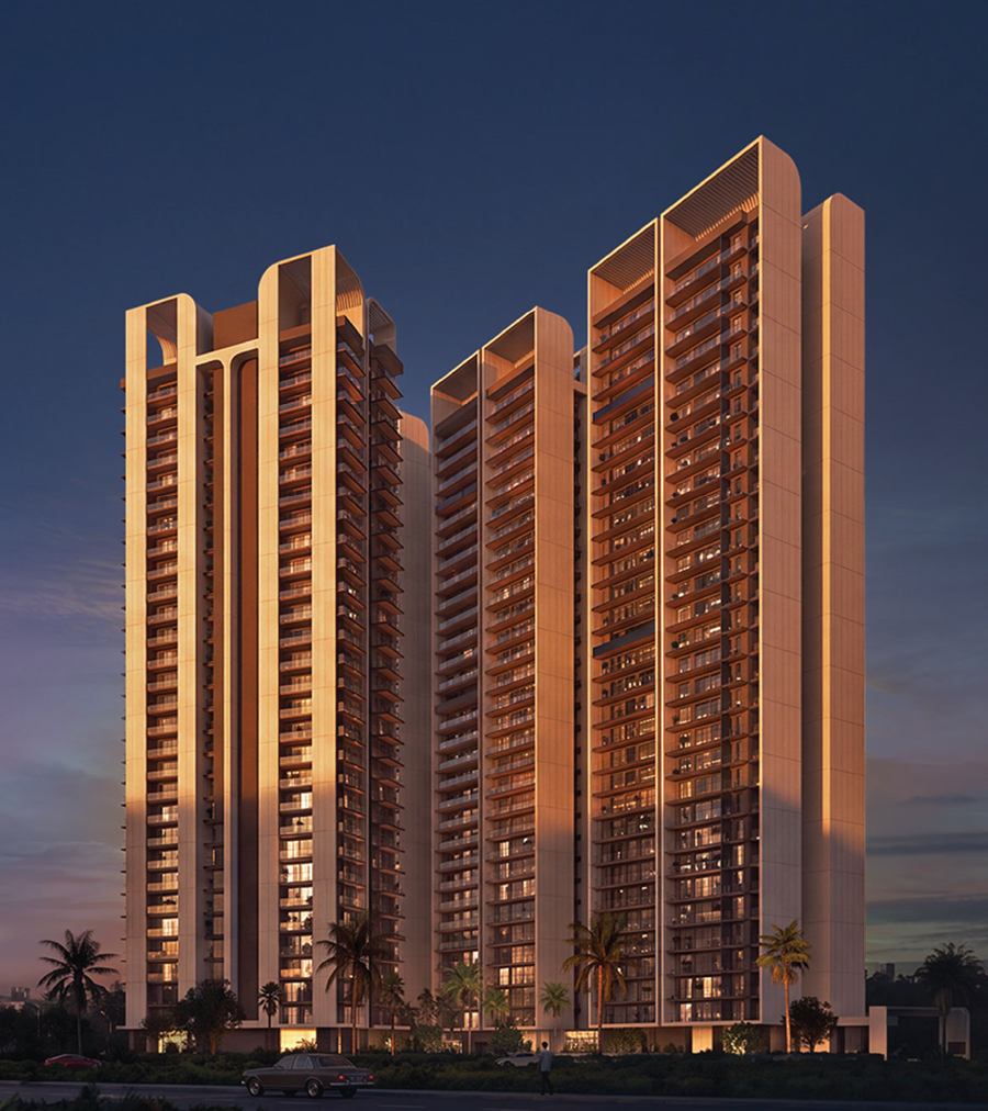 The four towers of The Aerth lit at dusk, seen from the approach road